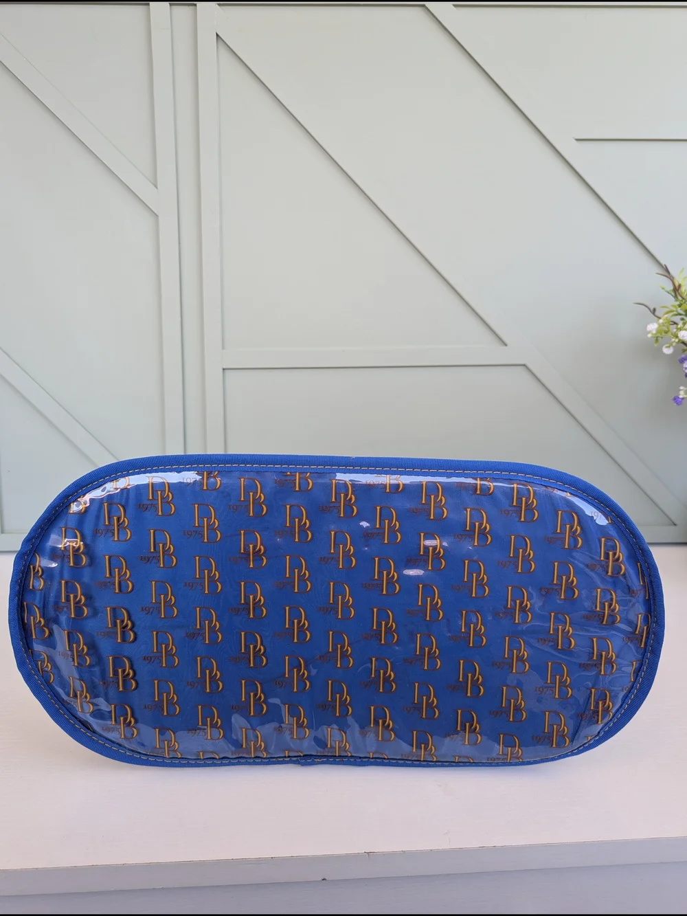 Dooney & Bourke Clear Tote with Blue Trim and Gold Logo Print